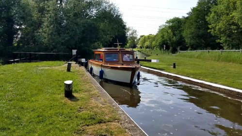 Classic runabout entering lock